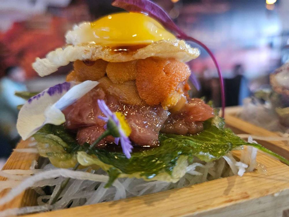 Toro tartare stacked with uni, caviar and a quail egg