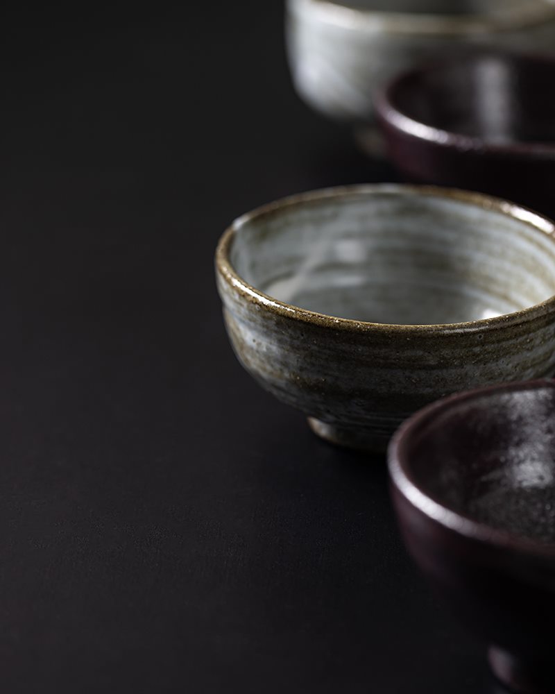 Hand-thrown Japanese ceramics on a dark table